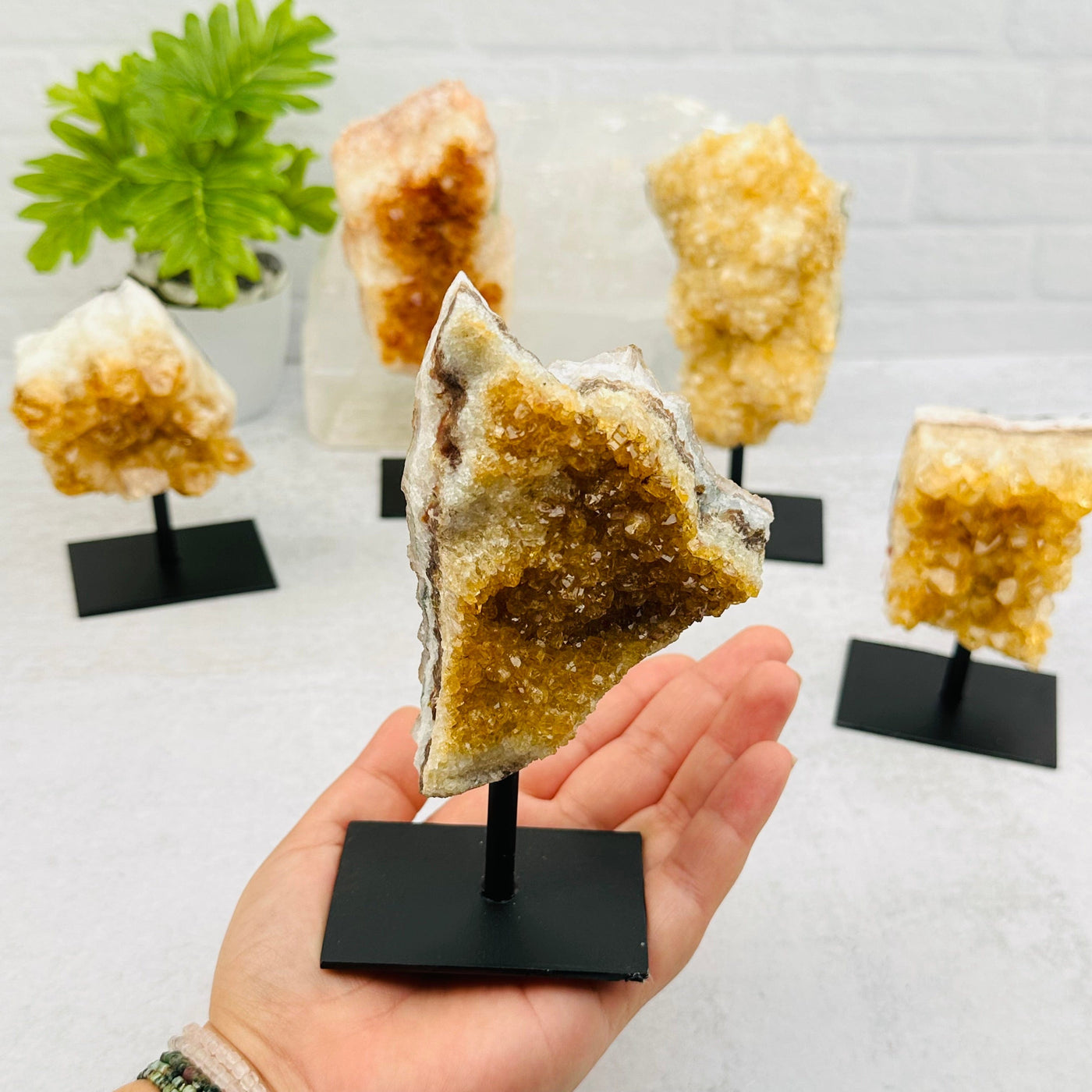 Citrine Cluster on Metal Stand in hand for size reference 