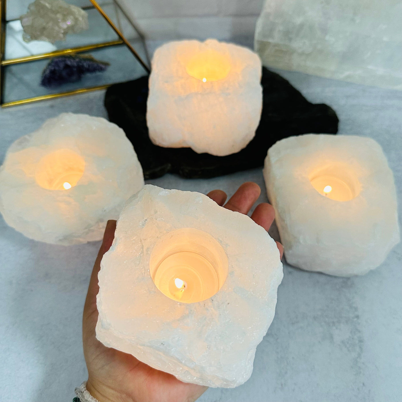 crystal quartz candle holder in hand for size reference 