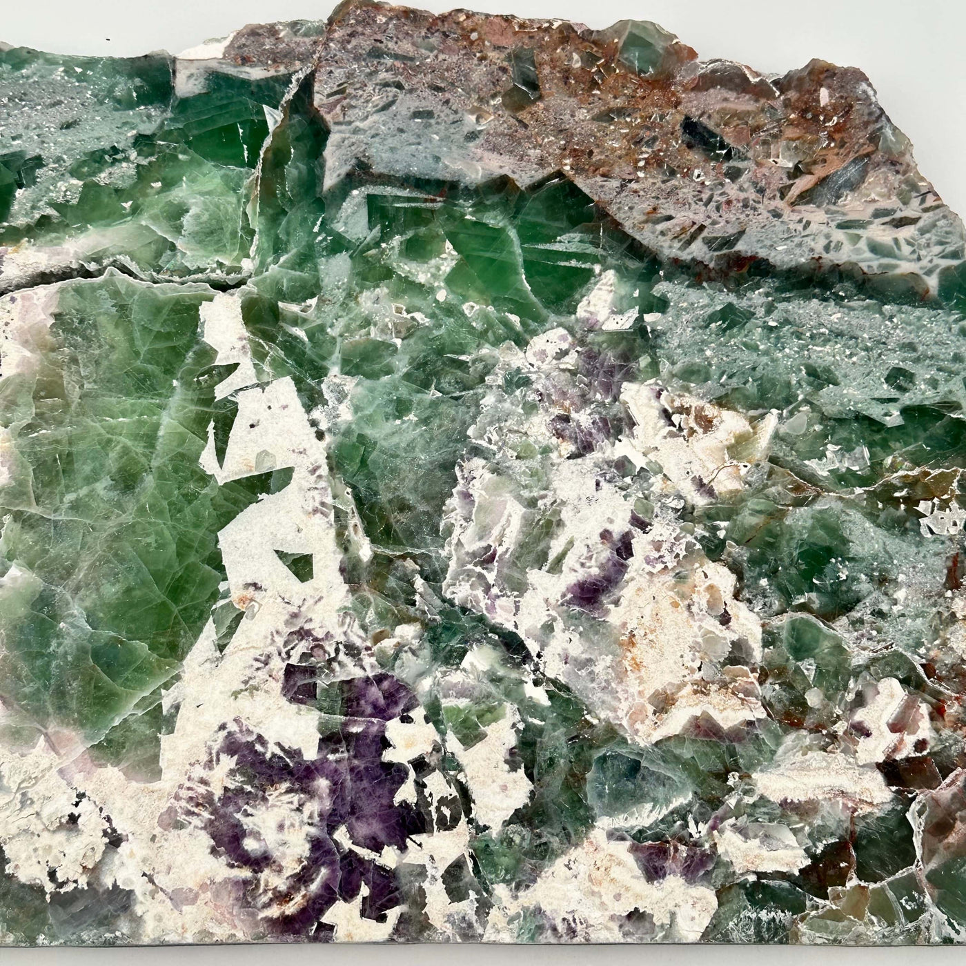 close up of the colorful patterns on this rainbow fluorite slab 