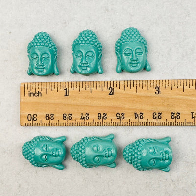 Turquoise Magnesite Buddha Beads  next to a ruler to show size