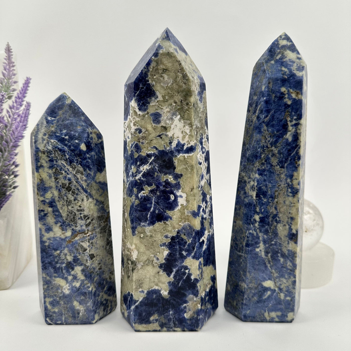 multiple  Sodalite Polished Crystal Point - You Choose - displayed as home decor 