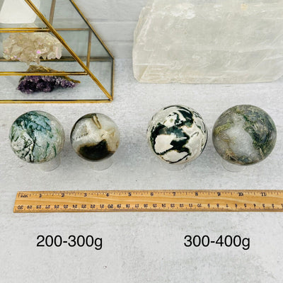 Moss Agate Spheres - By Weight - next to a ruler for size reference 