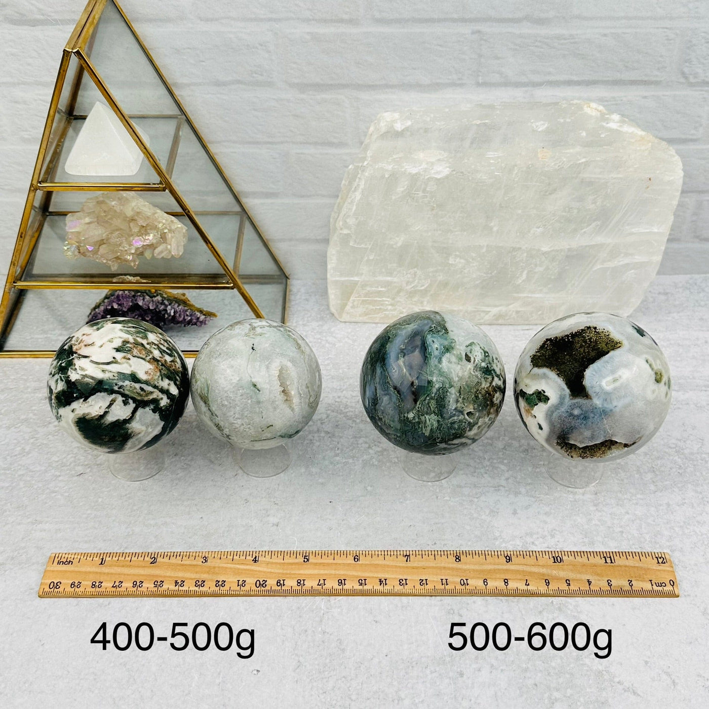 Moss Agate Spheres - By Weight - next to a ruler for size reference