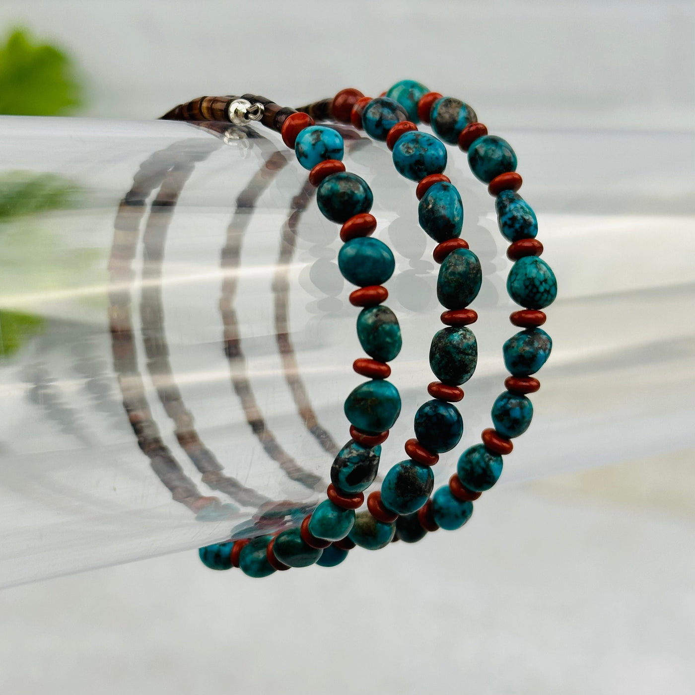 turquoise bracelet with puka shells with decorations in the background