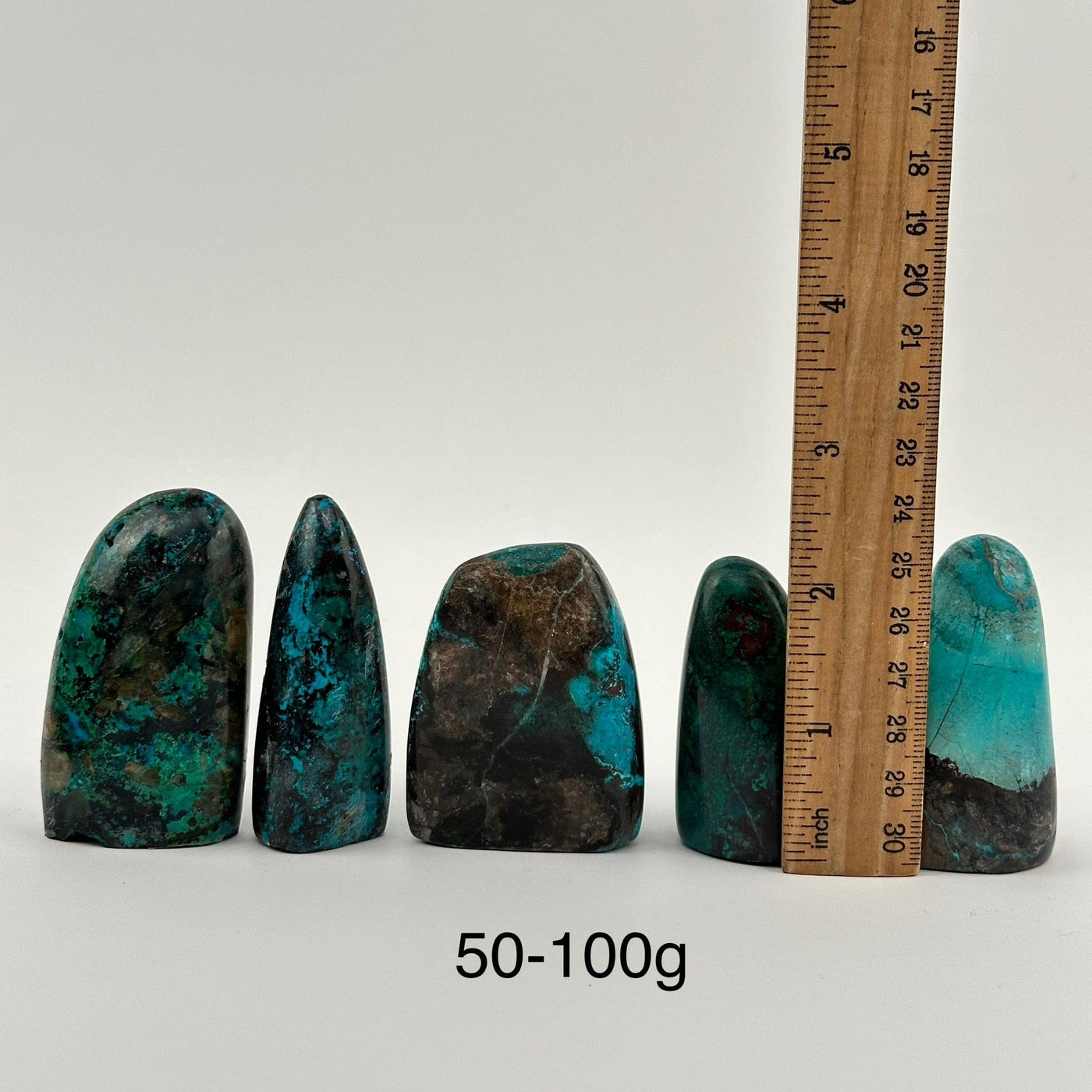 multiple Chrysocolla Crystal Cut Base from Peru displayed next to a ruler for size reference 