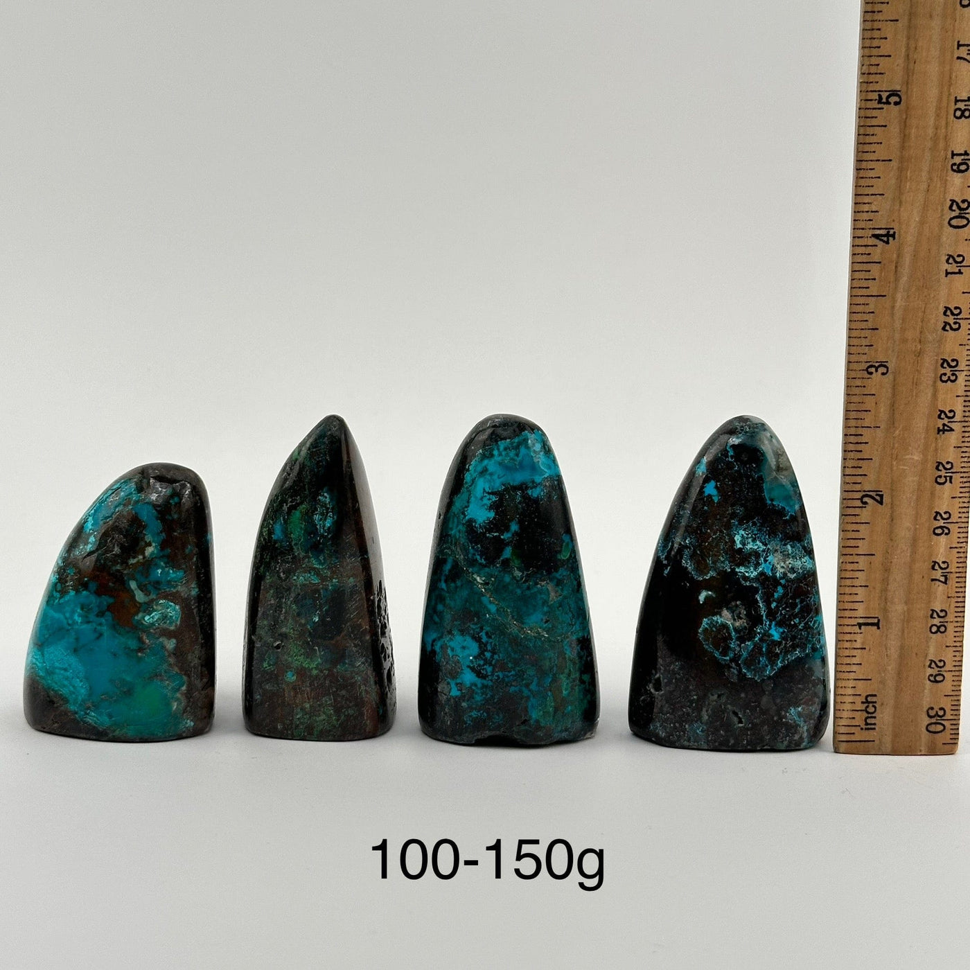 multiple Chrysocolla Crystal Cut Base from Peru displayed next to a ruler for size reference 