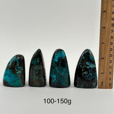 multiple Chrysocolla Crystal Cut Base from Peru displayed next to a ruler for size reference 