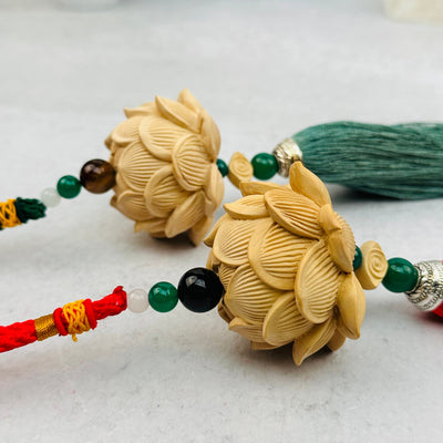 wooden lotus flower tassel with decorations in the background