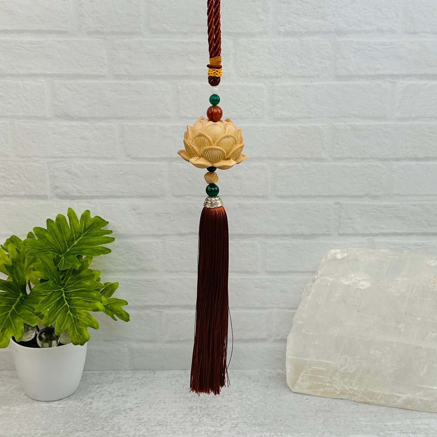 wooden lotus flower tassel with decorations in the background