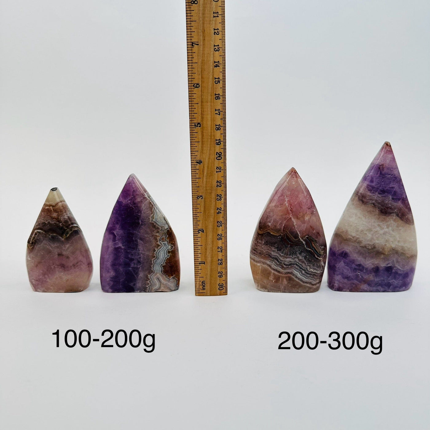 Amethyst Cut Base Polished Point - By Weight - next to a ruler for size reference 