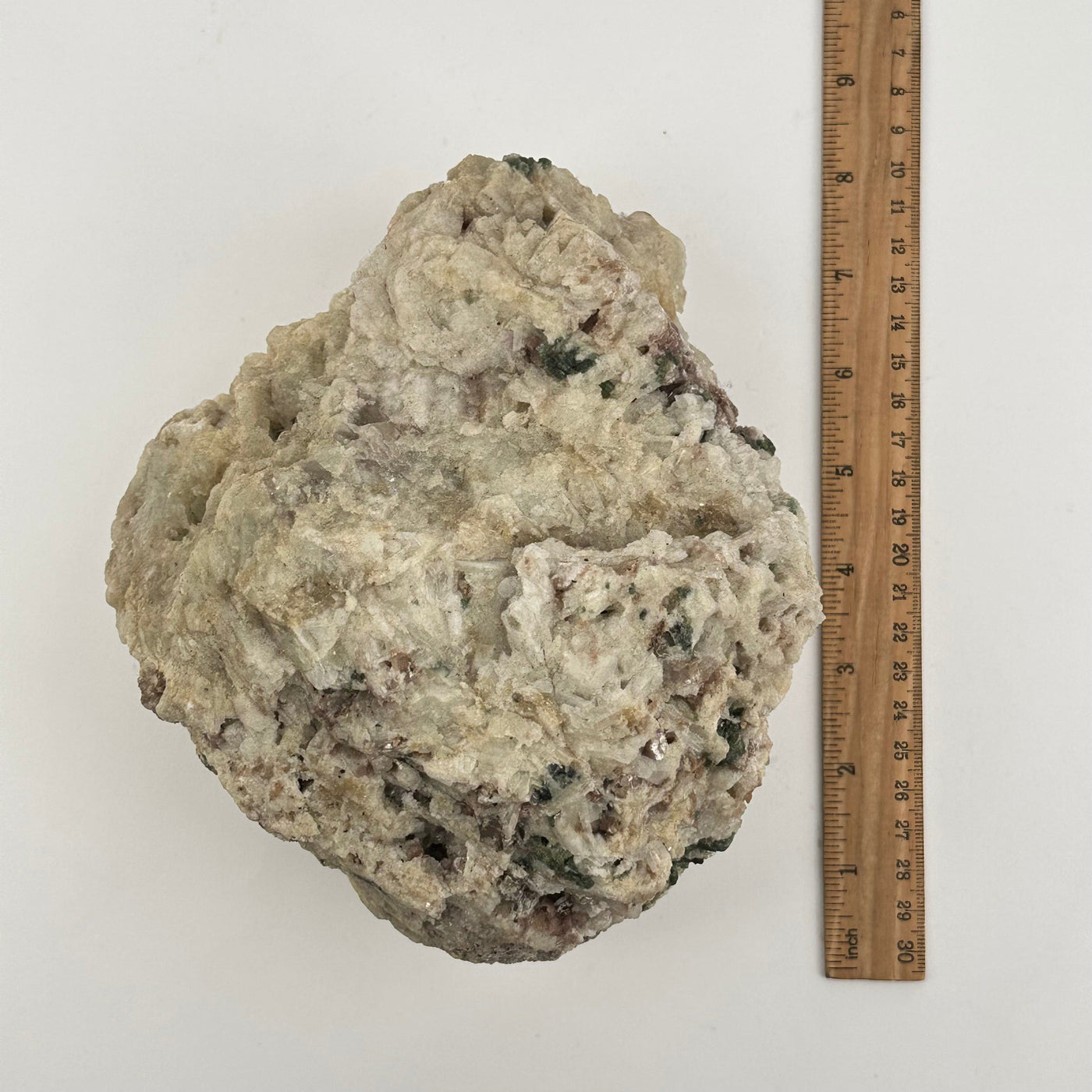 crystal cluster next to a ruler for size reference 