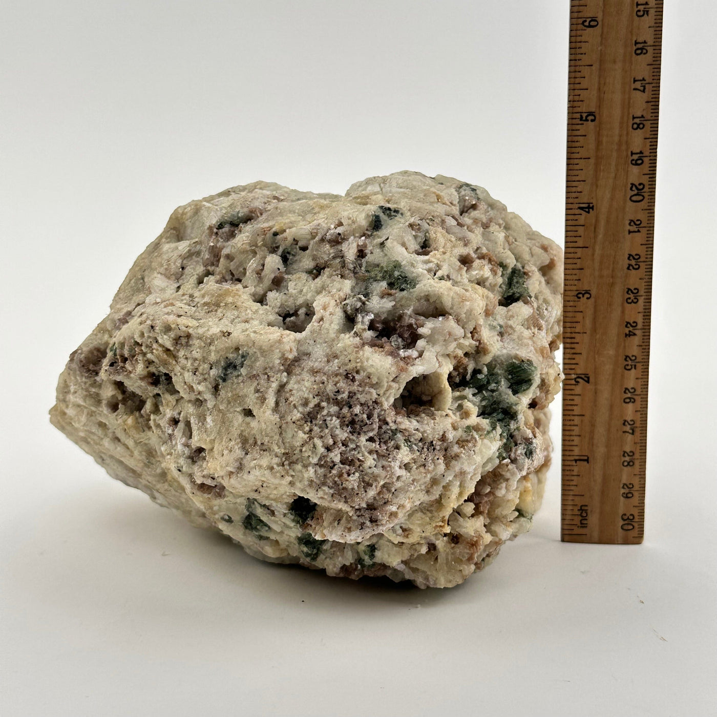 crystal cluster next to a ruler for size reference 