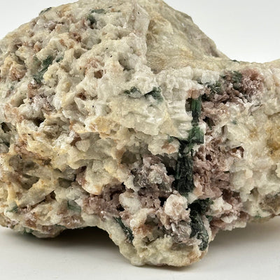 close up of the green and pink tourmaline rods on this crystal 