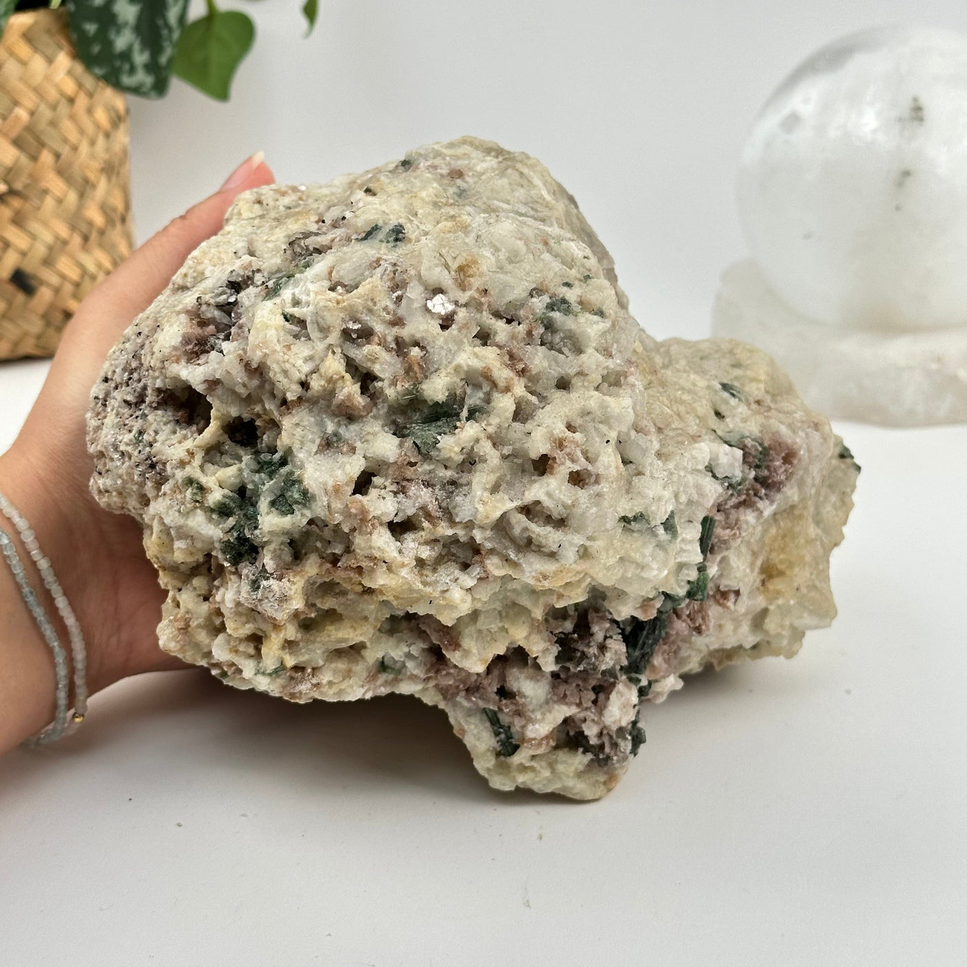 Watermelon Tourmaline on Matrix Crystal Cluster next to hand for size reference 