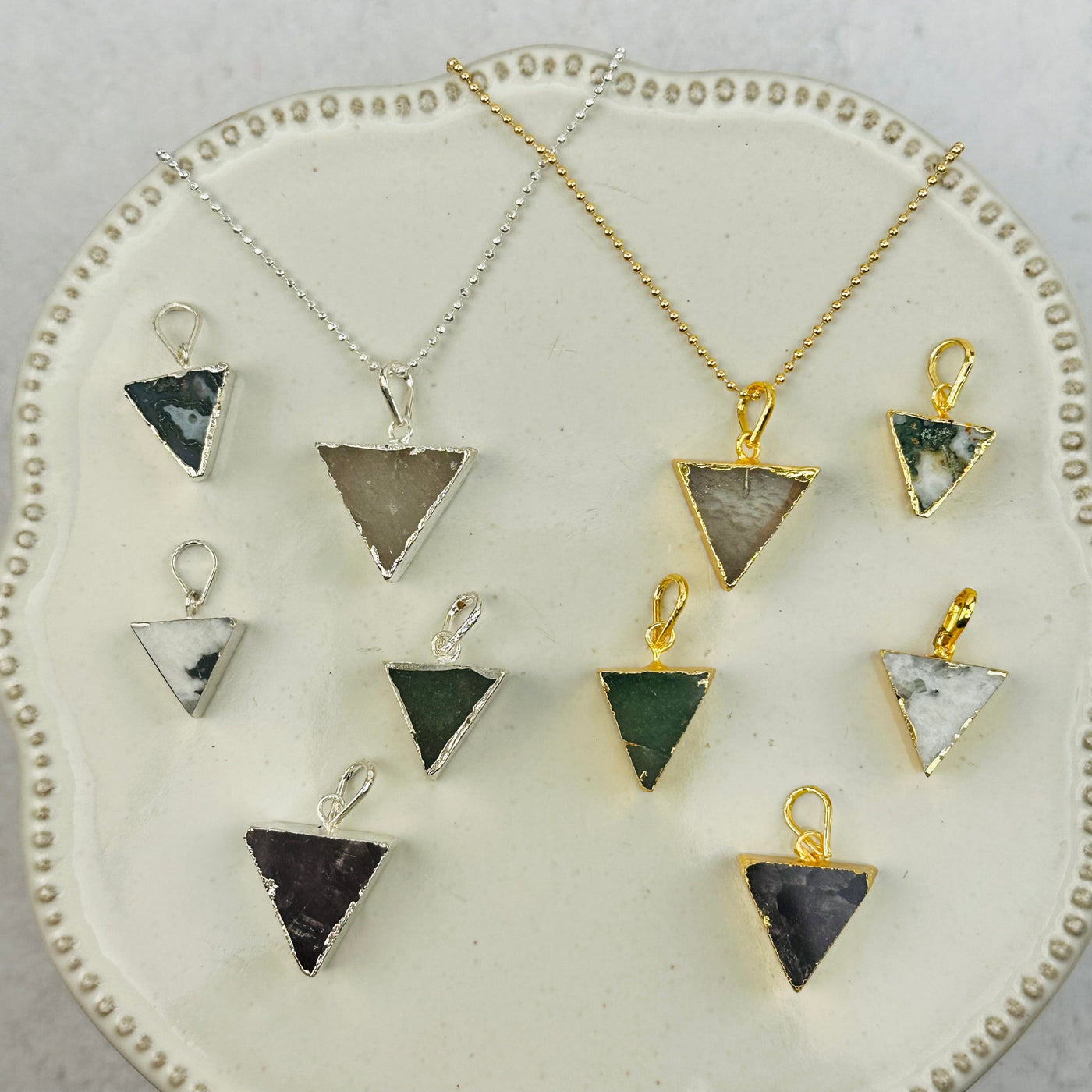 multiple pendants displayed to show the differences in the gemstone types 