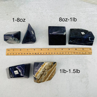Purple Opal Polished Stone - By Weight next to a ruler for size reference 