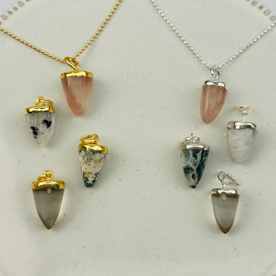 multiple pendants displayed to show the differences in the gemstone types