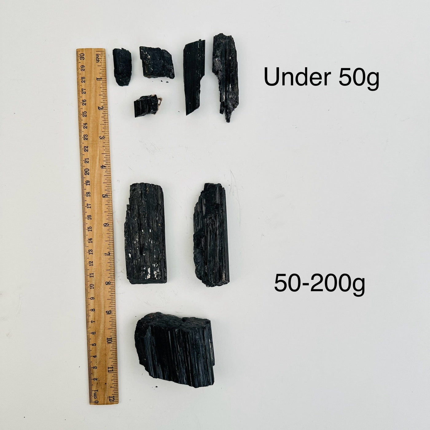 Natural Black Tourmaline - By Weight - next to a ruler for size reference