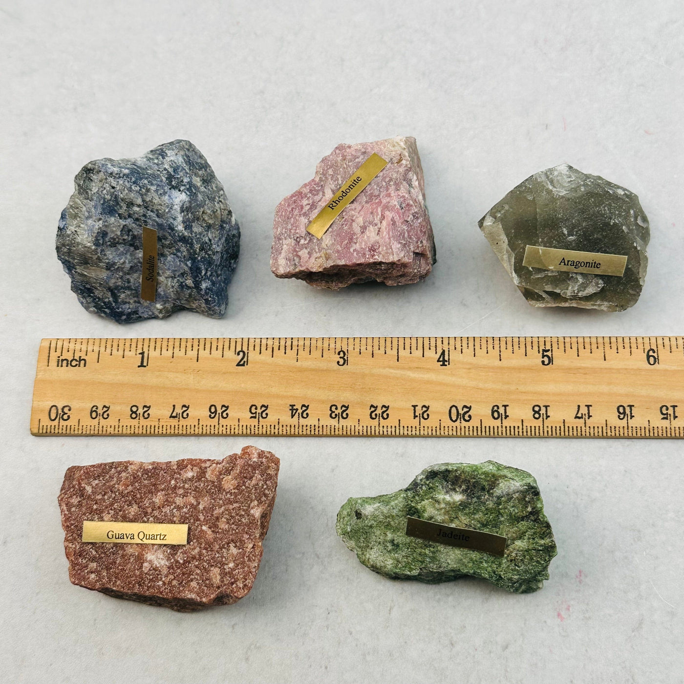 rough stones next to a ruler for size reference 