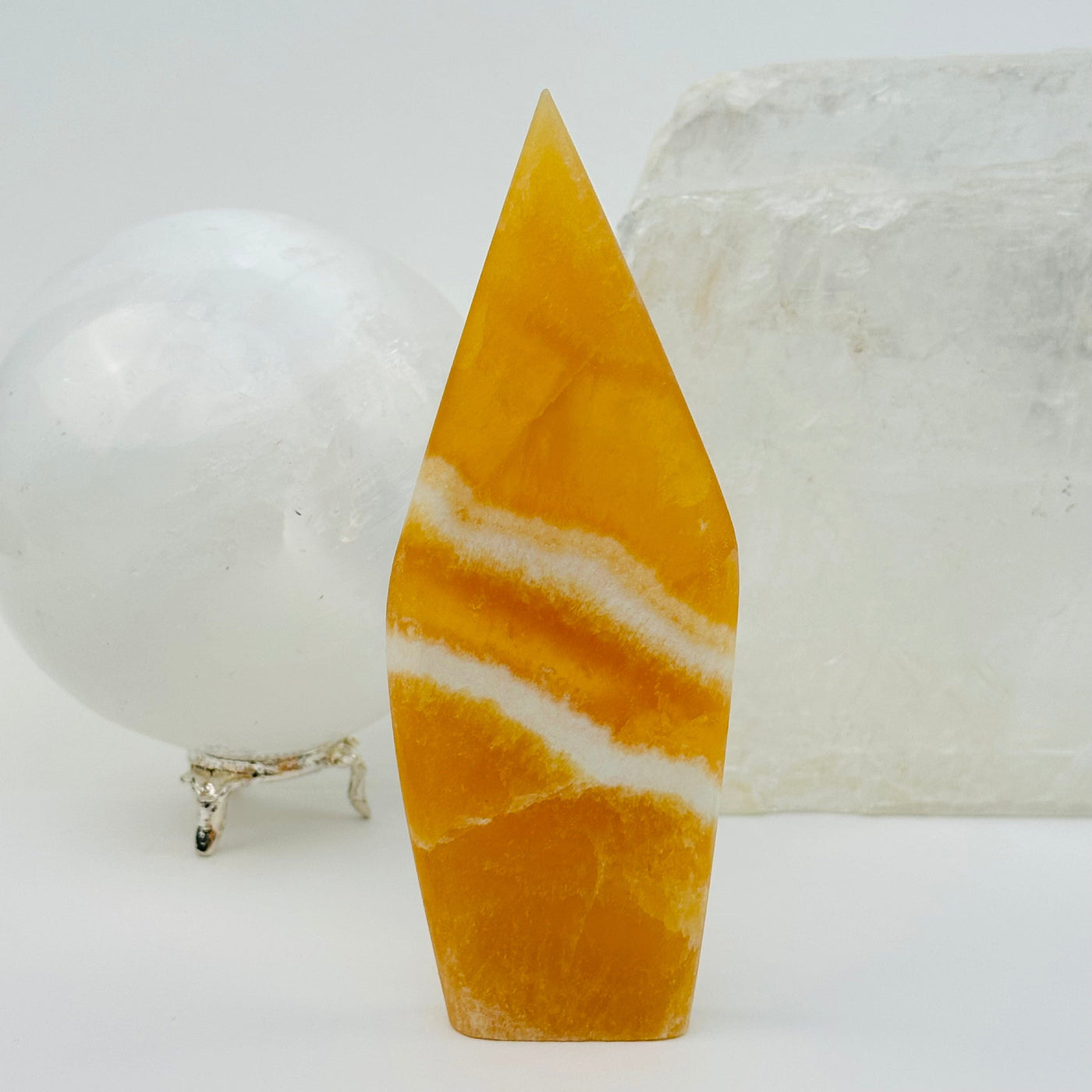 Banded Orange Calcite Crystal Point displayed as home decor 