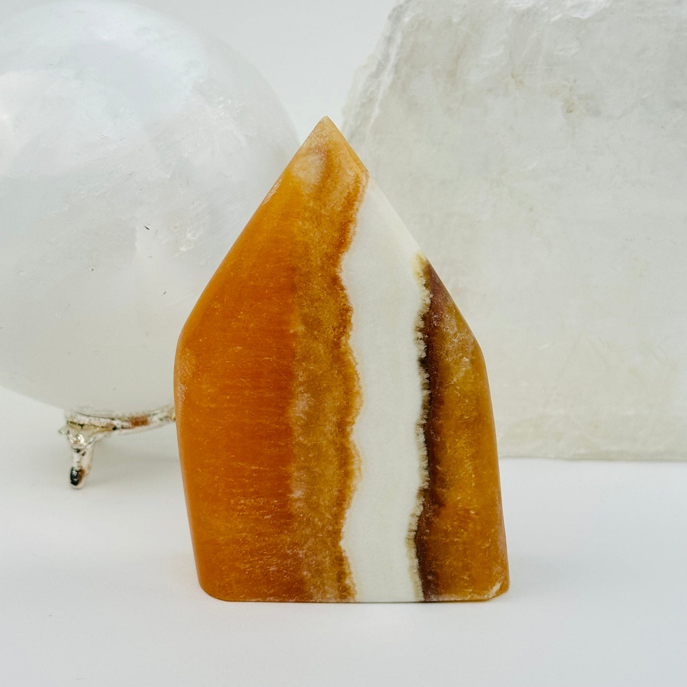 Banded Orange Calcite Crystal Point displayed as home decor 