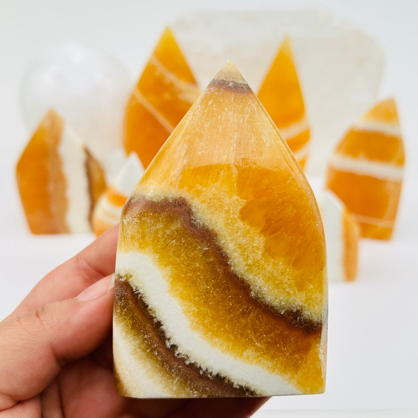 close up of the Banded Orange Calcite Crystal Point