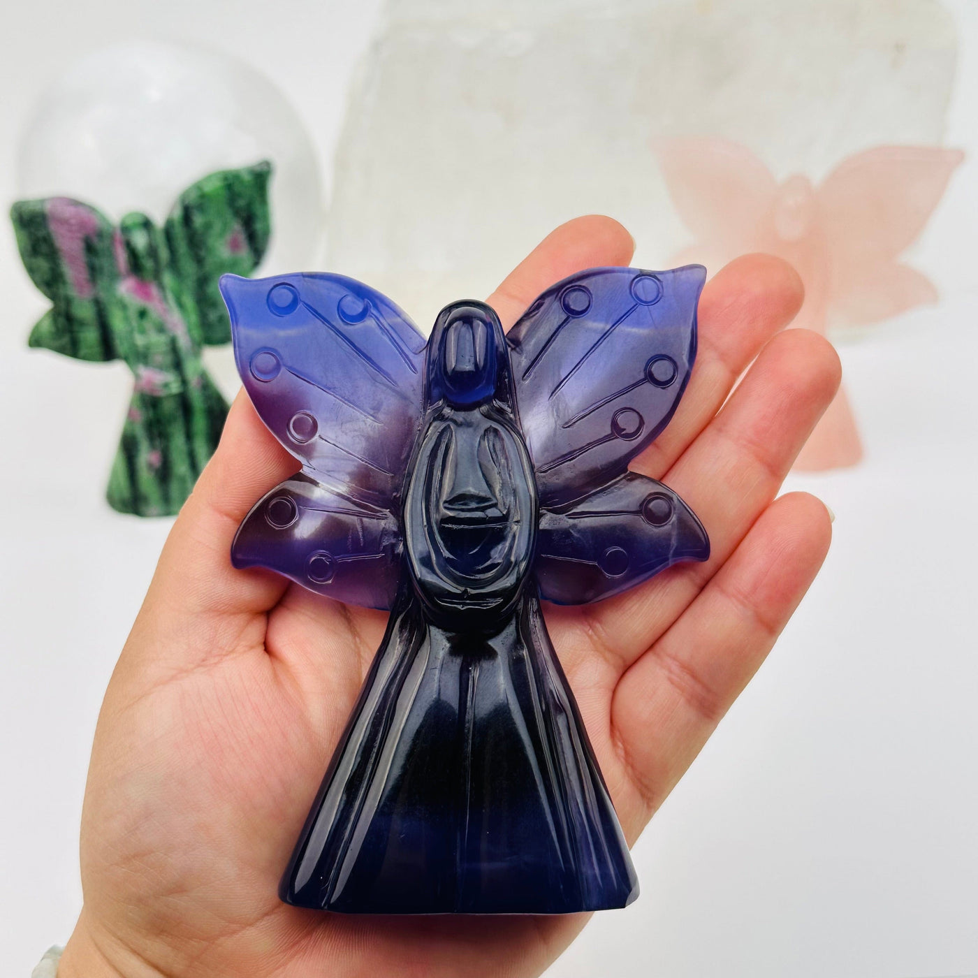 carved crystal angel in hand for size reference 