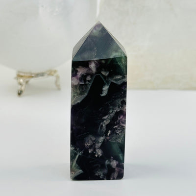 Rainbow Feathered Fluorite Crystal Polished Point Tower displayed as home decor 