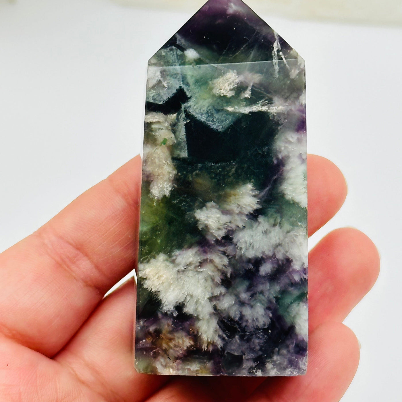 fluorite point in hand for size reference 