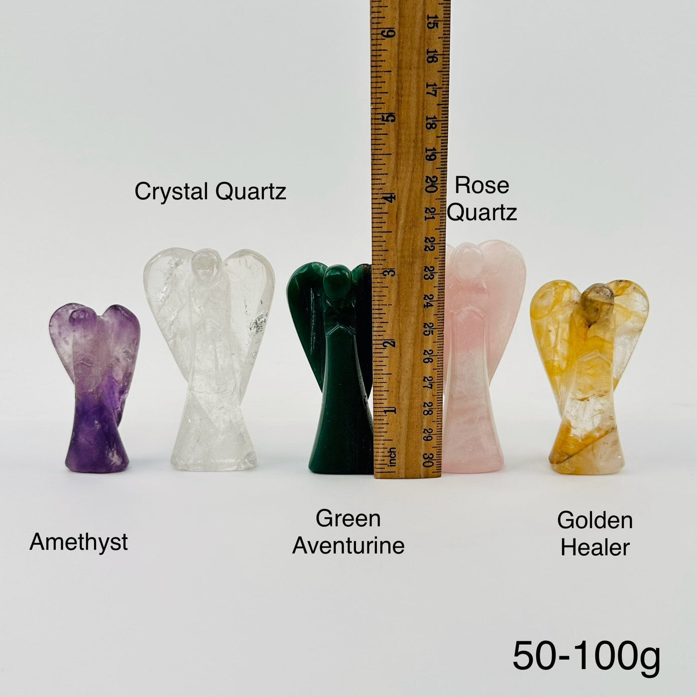 gemstone angels next to a ruler for size reference