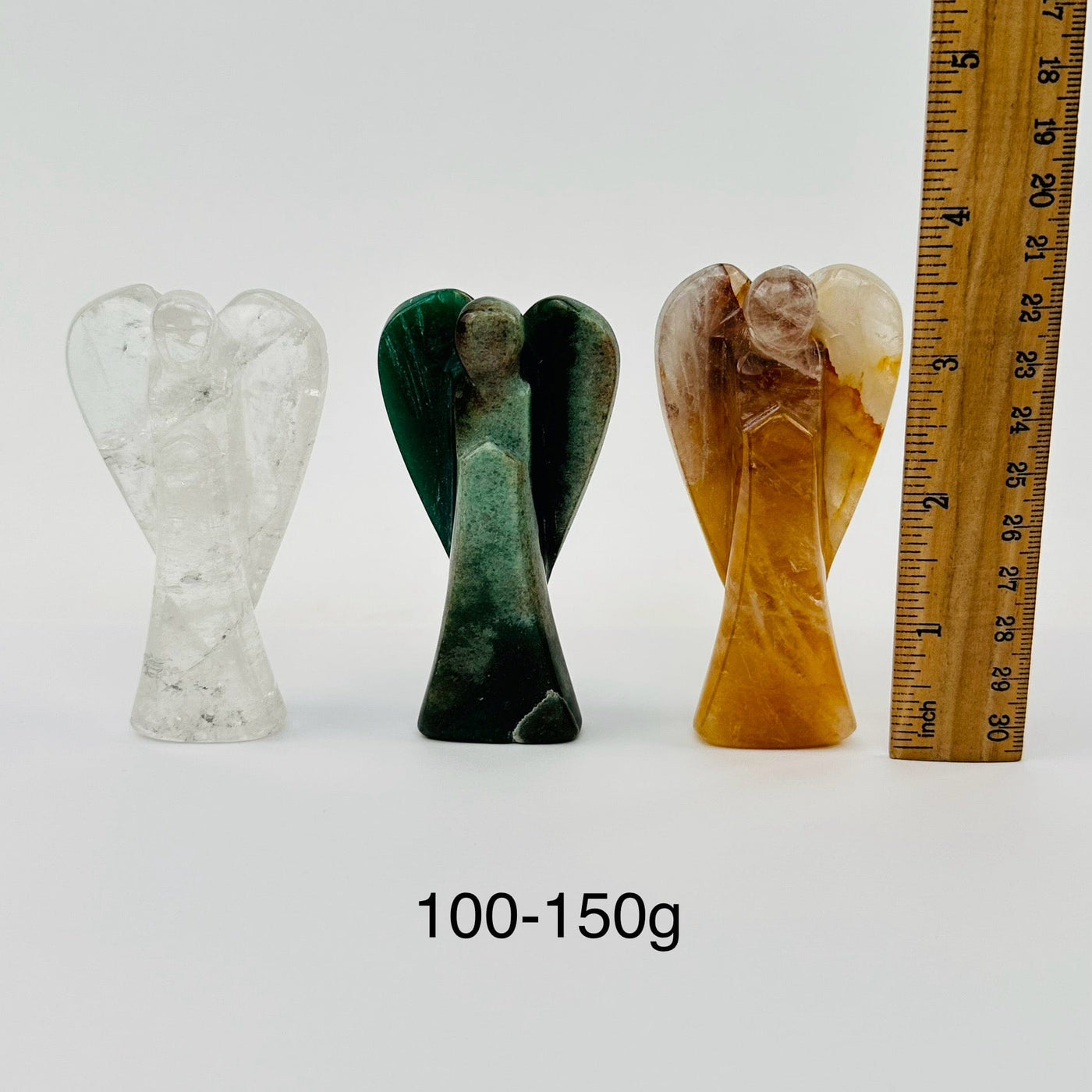 gemstone angels next to a ruler for size reference 