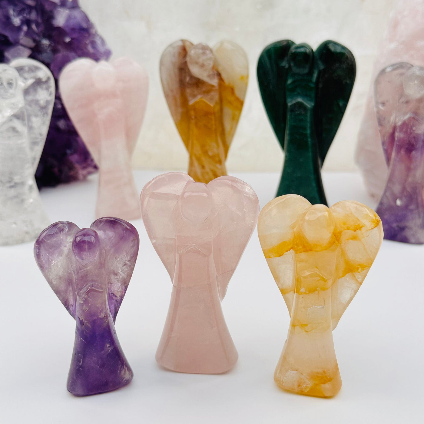 multiple  Crystal Gemstone Angels displayed to show the differences in the sizes and color shades 