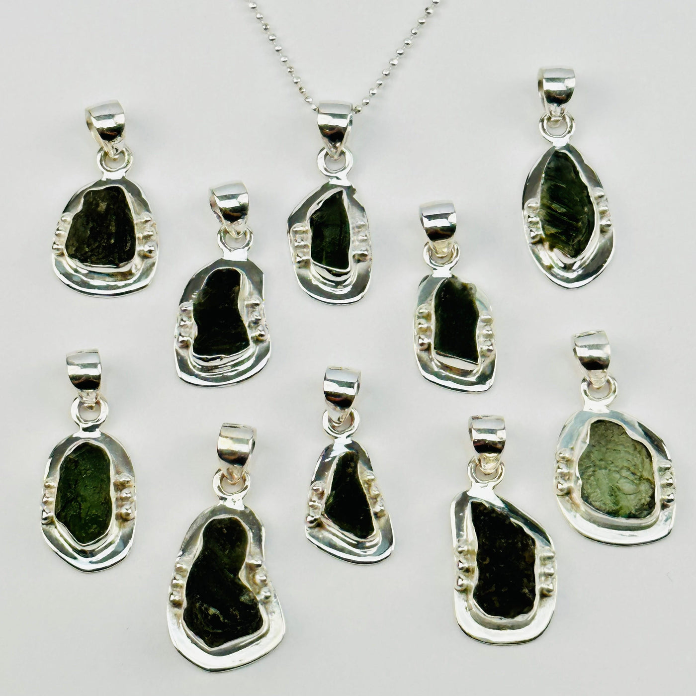 multiple pendants displayed to show the differences in the sizes available 