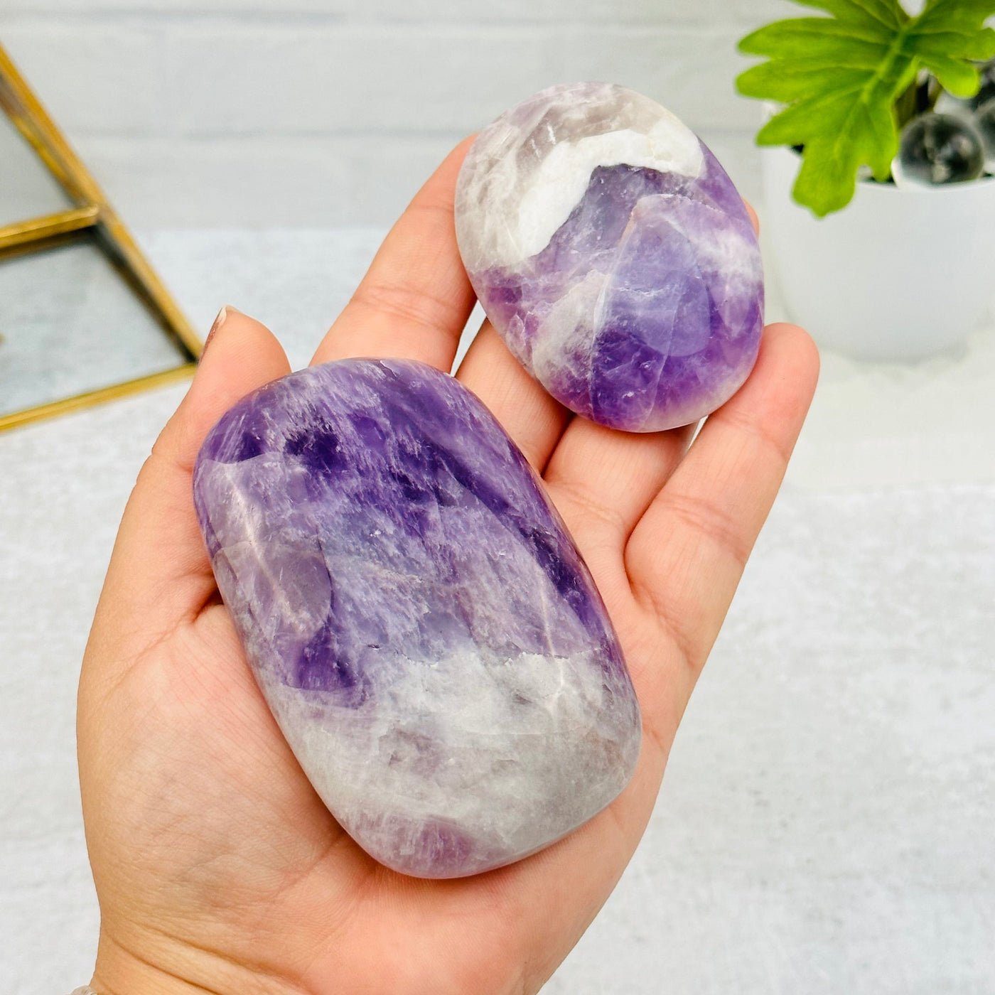 Chevron Amethyst Palm Stones in hand for size reference 
