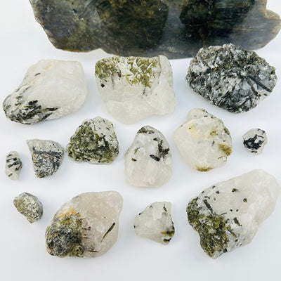 multiple Green Tourmaline Rough Crystal on Matrix displayed to show the differences in the sizes and color shades 