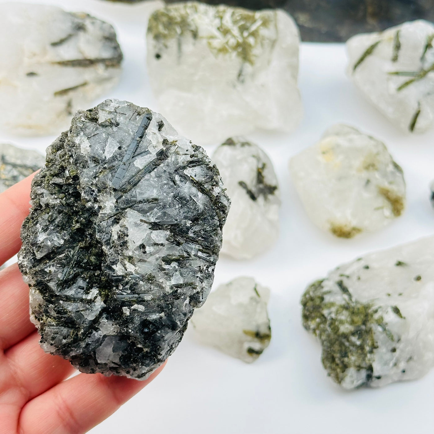 Green Tourmaline Rough Crystal on Matrix in hand for size reference 