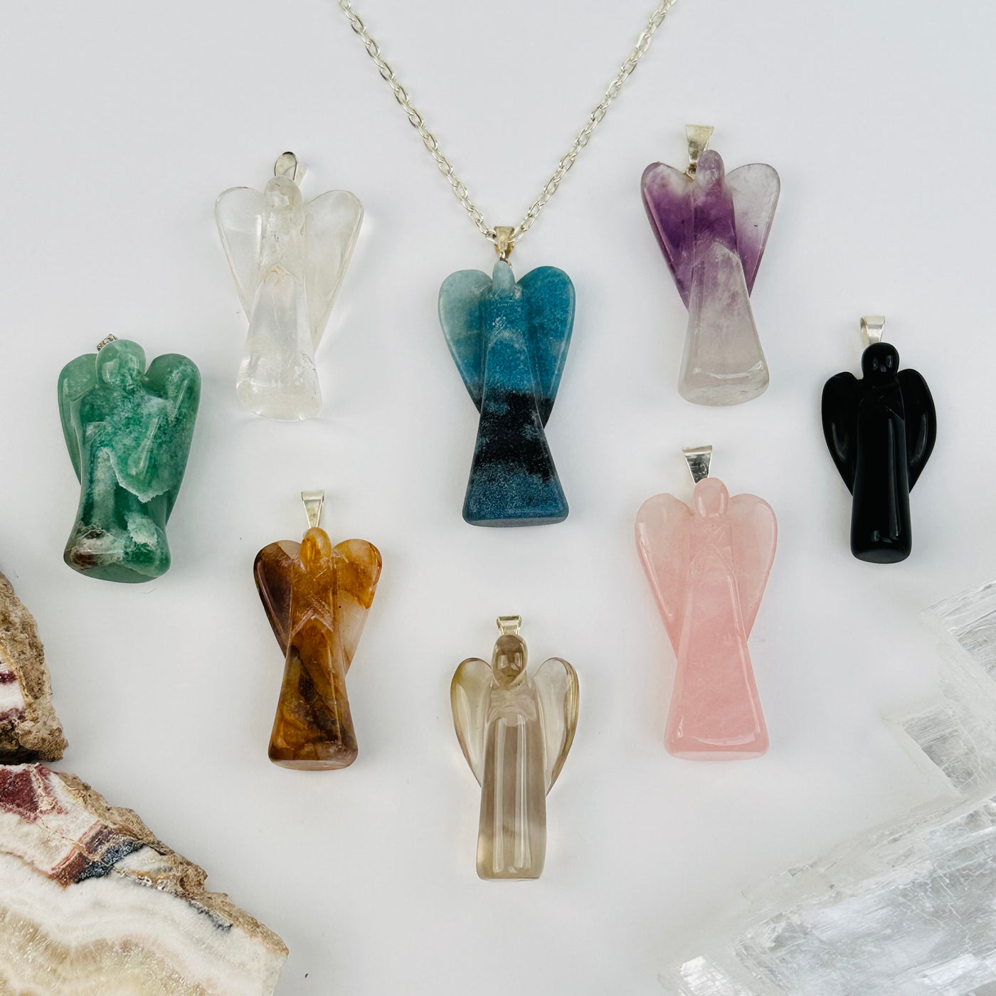 angel pendants displayed to show the differences in the sizes and color shades 