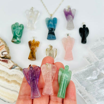 Crystal Guardian Angel Pendants in hand for size reference 