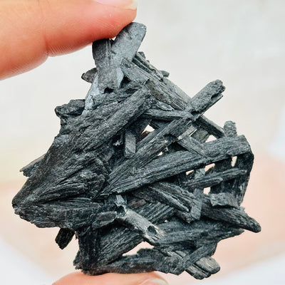 close up of the details on this black kyanite cluster to show the blades 