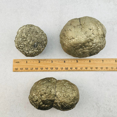pyrite nodules next to a ruler for size reference 