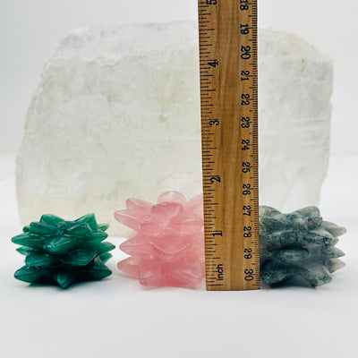 crystals next to a ruler for size reference 