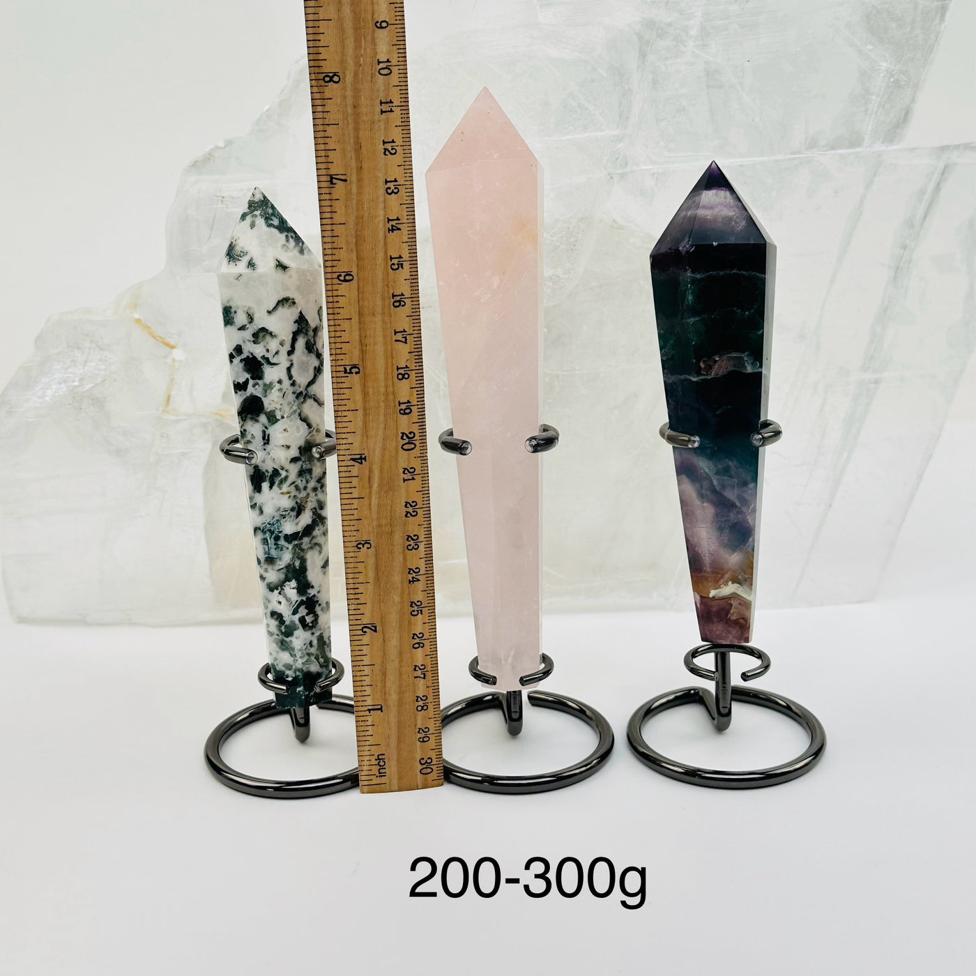 crystal wands on metal stand come sold by weight. displayed next to a ruler for size reference