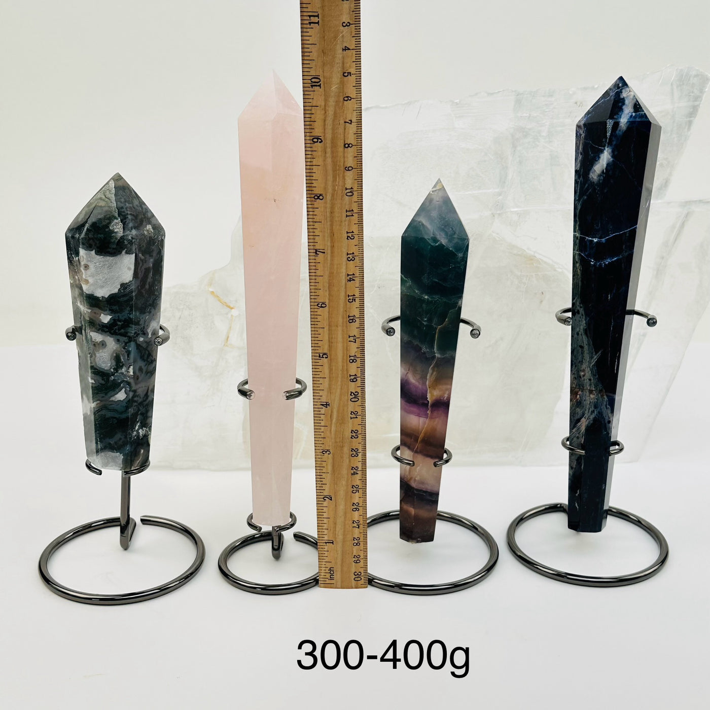 crystal wands on metal stand come sold by weight. displayed next to a ruler for size reference