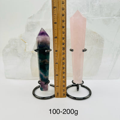 crystal wands on metal stand come sold by weight. displayed next to a ruler for size reference