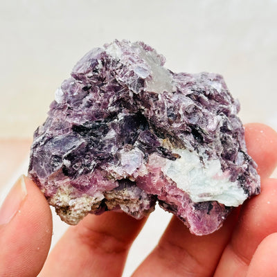 close up of the lepidolite and aquamarine on this crystal cluster