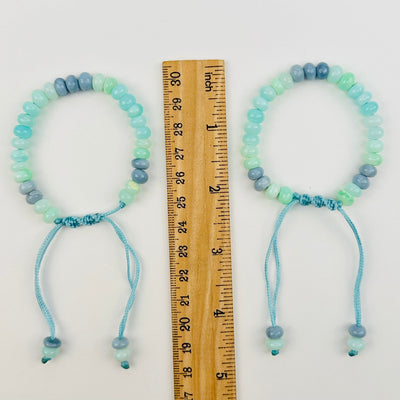 bracelets next to a ruler for size reference 