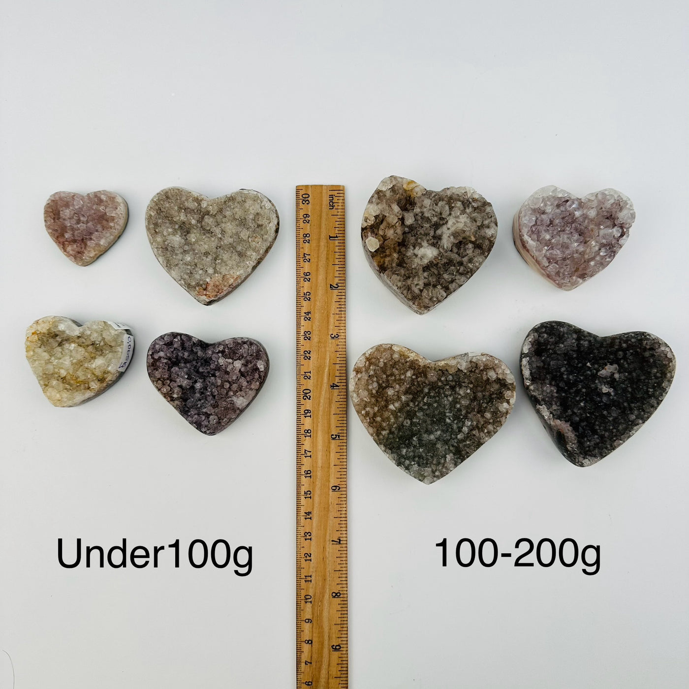 amethyst hearts sold by weight. next to a ruler for size reference