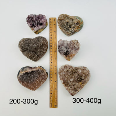 amethyst hearts sold by weight. next to a ruler for size reference