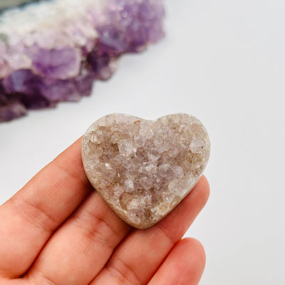 amethyst heart in hand for size reference