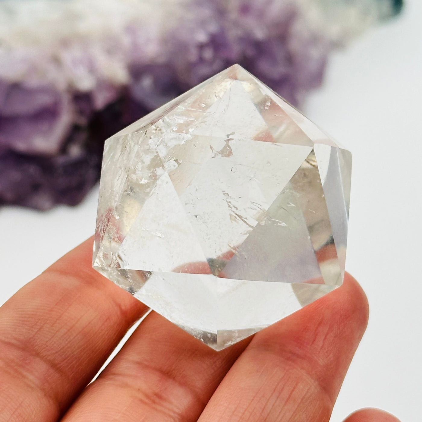 crystal quartz icosahedron in hand for size reference 